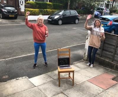Lizzie and friend Hannah celebrate their success watched by dad Gordon on Zoom
