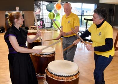 Mary Murata shows Rotary Club President Brian Joscelyne and fellow Rotarian Diana Naish the basics of Taiko drumming.jpg