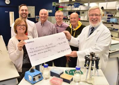 Organisers hand over their cheque to Professor Norman Maitland