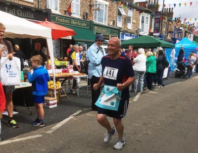 Joe Postill running in his Masonic apron